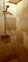 a shower with a hose in a bathroom at Mazille Les Trois Monts in Mazille