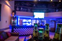 three bottles of beer sitting on a table in a bar at Sanafir Hotel - El Pacha Suites Sharm - Adults Only in Sharm El Sheikh