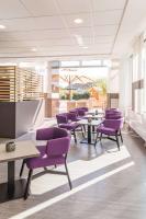 a waiting room with purple chairs and tables at Park Inn by Radisson Göttingen in Göttingen