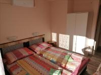 Łóżko lub łóżka w pokoju w obiekcie Cserke Gyöngye Apartman