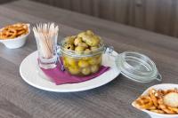a jar of food sitting on a plate with snacks at Best Western Hotel Le Bordeaux Sud in Gradignan