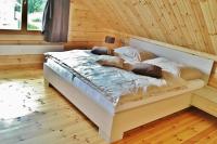 A bed or beds in a room at Chata Natan