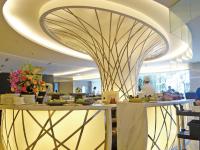 a restaurant with a curved ceiling and a counter with food at City Suites - Kaohsiung Chenai in Kaohsiung