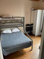 a bedroom with two bunk beds and a small bed at RENT APPART - Colombes in Colombes
