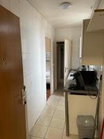 a small kitchen with a sink and a toilet in a room at RENT APPART - Colombes in Colombes
