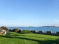 a field of grass with the ocean in the background at Studio La Garde by Interhome in Dinard