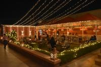 a building covered in lights with people sitting in chairs at Hotel The Balam in Jodhpur