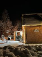 a building with a lit up doorway in the snow at Villa Breza Brezovice in Brezovica