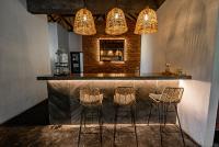 a bar with three stools and three lights at Village Bali in Uluwatu