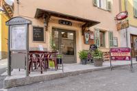 a cafe with tables and chairs outside of a building at Hotel Pascal in Allos