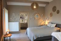 a bedroom with a bed and a sign that reads a room of angels at La Veraison in Malmedy