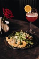 a plate of food with a salad and a drink at Garden plaza in Neresnytsya