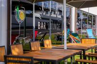 a wooden table and chairs in front of a barounge at ARGENTA Living 16 in Künzell