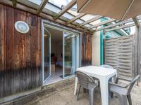 a patio with a white table and chairs at Holiday Home Cottage Confort 3 Pers- by Interhome in Saumur
