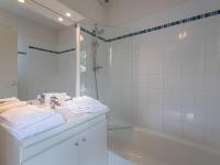 a bathroom with a tub and a sink and a mirror at Holiday Home Cottage Confort 3 Pers- by Interhome in Saumur