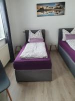 A bed or beds in a room at Glemmy Appartements inkl Sommercard