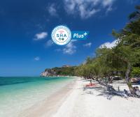 a beach with a sign that says slsa plus at Sarikantang Resort & Spa, Koh Phangan in Haad Rin