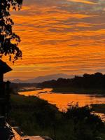 a view of a river at sunset at Rio Vista Lodge in Malelane