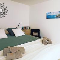 a bedroom with two beds with towels on the bed at Chambre &amp; Caux in Thiergeville