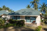 a house with a porch with palm trees at Gooddays Lanta Beach Resort SHA in Ko Lanta