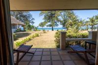 a porch with two chairs and a view of the beach at Gooddays Lanta Beach Resort SHA in Ko Lanta