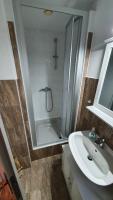 a bathroom with a shower and a sink and a tub at Pension am Silberberg in Gartz an der Oder