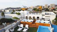a balcony with chairs and a swimming pool on a building at Hotel Parque de los Novios Inn in Santa Marta