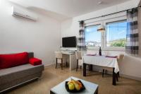 Televízia a/alebo spoločenská miestnosť v ubytovaní Beach Apartments in Stobrec