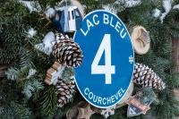 a blue sign on a christmas tree at Les Monts Charvin in Courchevel