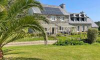 a large house with solar panels on it at Lescoat-le petit paradis in Plestin-les-Grèves