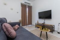 Televízia a/alebo spoločenská miestnosť v ubytovaní Bloom Apartment