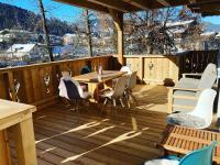 a wooden deck with a table and chairs on it at Bee happy Haus Burböck in Flachau