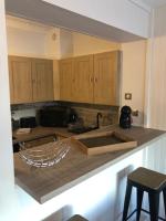 a kitchen with wooden cabinets and a counter top at Hôtel Beau Rivage in Royan