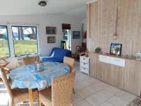 a kitchen and dining room with a table and chairs at Holiday home in a secluded location surrounded by the sea, Hanvec in Hanvec