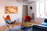 a living room with two chairs and a couch at Jolie maison proche centre-ville et plages in Granville