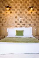a bedroom with a large white bed with wooden walls at La Course in Bordeaux