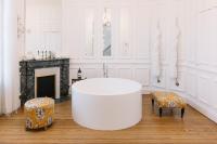 a white room with a white tub and a fireplace at La Course in Bordeaux