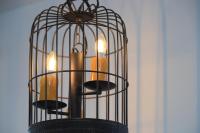 a bird cage with three candles in it at Alishan B&amp;B YunMinGi in Fenqihu