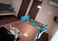 a dining room table with blue chairs and a pot on it at Mobile Home Sea Shell Šime, Drage in Drage