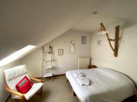 a bedroom with a bed and a ladder and a chair at Auberge du Savel in Clavans-en-Haut-Oisans