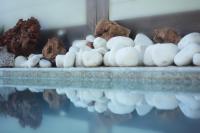 a bunch of balls of white rocks on a shelf at PLEIADES lUXURY APARTMENTS in Porto Heli