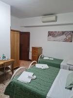 Łóżko lub łóżka w pokoju w obiekcie LA PALAZZINA