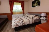 A bed or beds in a room at Erika Vendégház