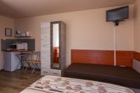 A bed or beds in a room at Erika Vendégház