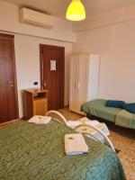 Łóżko lub łóżka w pokoju w obiekcie LA PALAZZINA