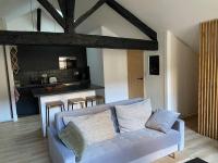 a living room with a blue couch and a kitchen at Bordeaux Chéri in Bordeaux