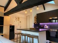 a kitchen with a counter and stools in it at Bordeaux Chéri in Bordeaux
