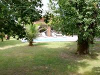 a house with a swimming pool and two trees at holiday home, Grayan-et-l&#39;Hôpital in Grayan-et-lʼHôpital