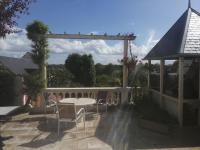 a patio with a table and chairs and a fence at Jolie maison atypique à Montrichard in Montrichard