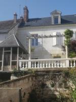 a white house with a white fence in front of it at Jolie maison atypique à Montrichard in Montrichard